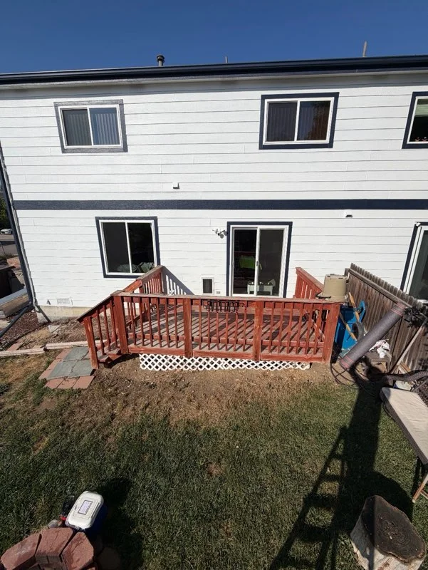 Curved composite deck with white checkerboard border and curved wood railing system